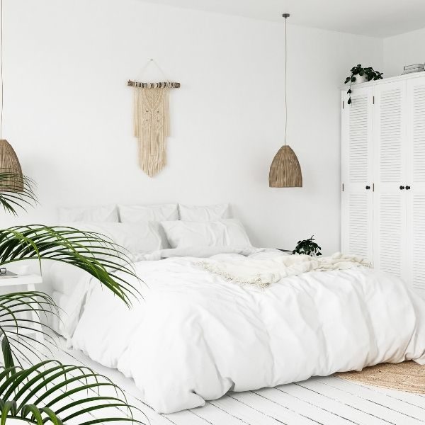 A modern and bright bedroom with natural boho decor cared for by The Cleaning Experts' maid services.